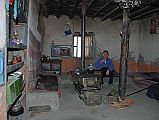 Mustang 01 04-3 Tange My Room I stayed in the main room of a house in Tange, sleeping on a Tibetan carpet on a bench by the wall. I enjoyed a nice Pepsi to celebrate being out of the wind.